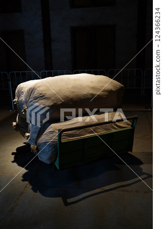 A suspicious burlap sack in the dark A suspicious burlap sack in the dark 124366234