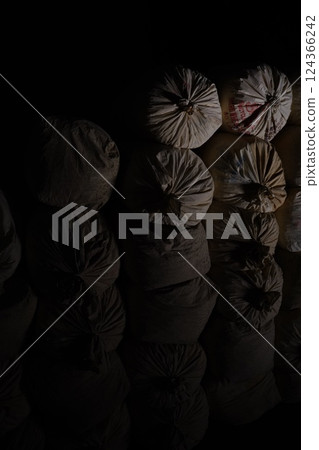 A suspicious burlap sack in the dark A suspicious burlap sack in the dark 124366242