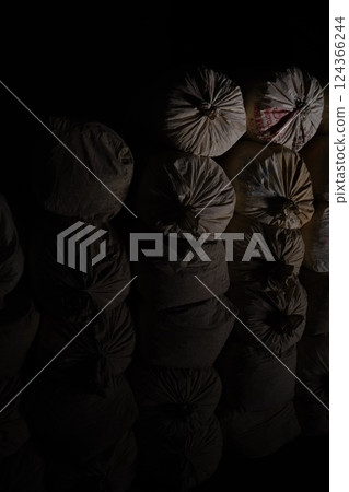 A suspicious burlap sack in the dark 124366244