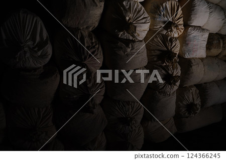 A suspicious burlap sack in the dark A suspicious burlap sack in the dark 124366245
