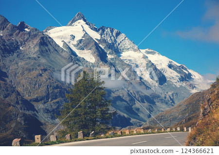 Mountain landscape. Mountain road and blue sky. Grossglockner High Alpine Road. Austria, Europe Mountain landscape. Mountain road and blue sky. Grossglockner High Alpine Road. Austria, Europe 124366621