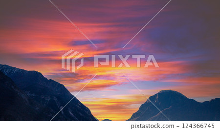 Beautiful mountains against sunset sky.  Silhouette of mountains peaks during sunset 124366745