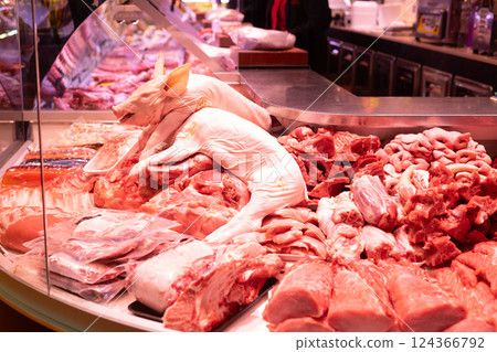 Raw piglet whole carcass in refrigerator cabinet of butcher shop Raw piglet whole carcass in refrigerator cabinet of butcher shop 124366792
