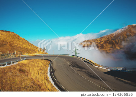 Alpine winding highway above the clouds. Pyrenees, Andorra, Europe 124366836