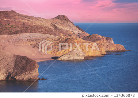 Rocky coast during sunset. Seascape in the evening. Nature Reserve Cabo de Gata Nijar. Almeria, Andalusia, Spain 124366878