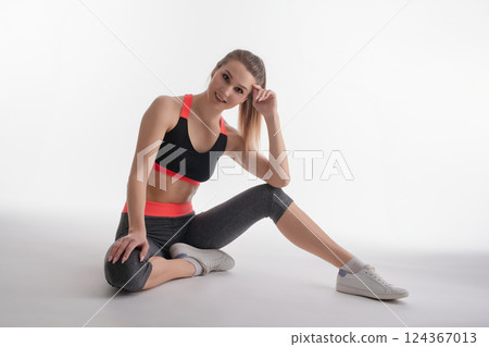 Woman posing in sporty outfit during studio session for fitness photography 124367013