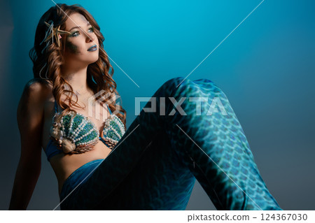 Mermaid cosplay with intricate body art in an aquatic-themed setting 124367030