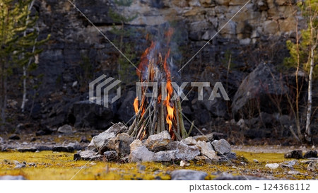 Beautiful Crackling Campfire in a Rocky Landscape , Sunrise , Authentic Place Beautiful Crackling Campfire in a Rocky Landscape , Sunrise , Authentic Place 124368112