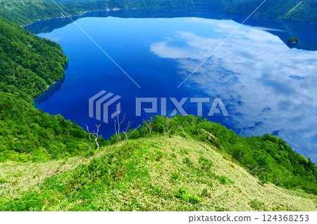 初夏的摩週湖倒映著天空。日本北海道弟子屈町。六月下旬。 初夏的摩週湖倒映著天空。日本北海道弟子屈町。六月下旬。 124368253