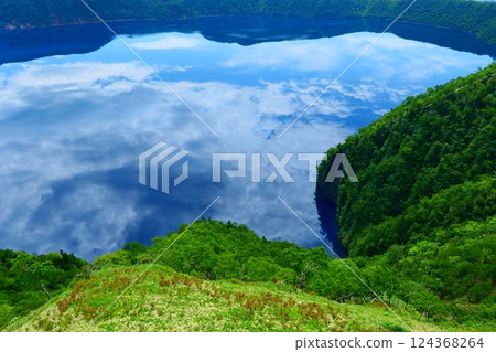 Lake Mashu reflecting the sky in early summer. Teshikaga, Hokkaido, Japan. Late June. 124368264