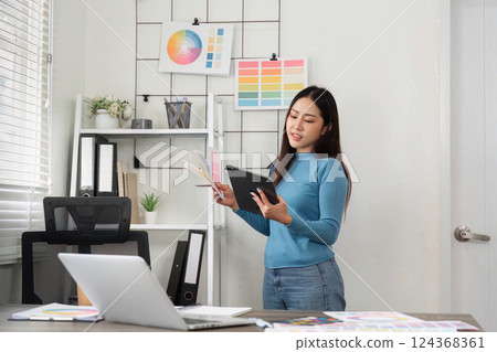 Creative Color Decisions. A designer proudly discussing chosen color swatches on a digital device. Creative Color Decisions. A designer proudly discussing chosen color swatches on a digital device. 124368361