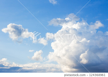 white cumulus clouds on a blue sky. beautiful nature background in afternoon light. sunny weather in summer white cumulus clouds on a blue sky. beautiful nature background in afternoon light. sunny weather in summer 124368961