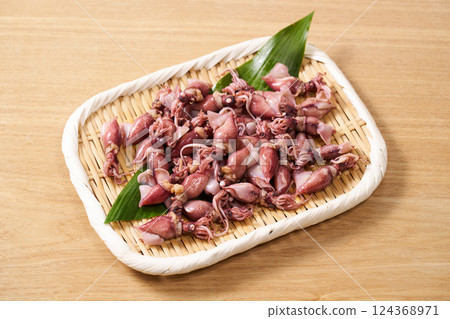 Firefly squid on a colander Firefly squid on a colander 124368971