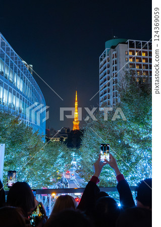 TOKYO, JAPAN - Nov 8, 2024: People taking picture of Tokyo tower at Roppongi Hills TOKYO, JAPAN - Nov 8, 2024: People taking picture of Tokyo tower at Roppongi Hills 124369059