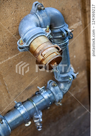 Piping and connection on a stone wall 124369217