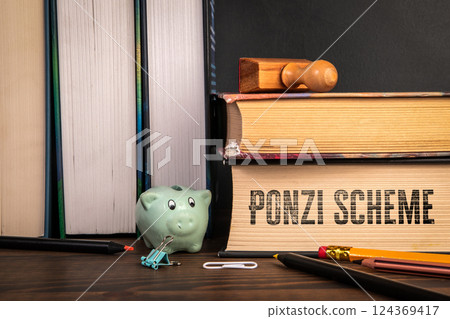 Ponzi Scheme. Stack of books on a wooden shelf Ponzi Scheme. Stack of books on a wooden shelf 124369417