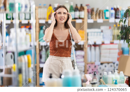 Young girl having headache in supermarket 124370065