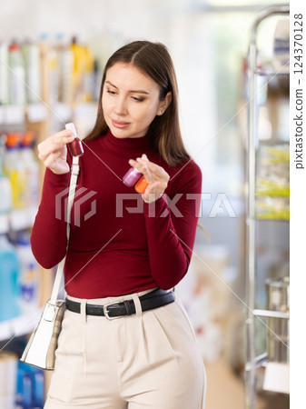 Woman choosing nail polishes 124370128