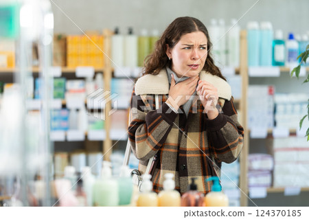 Young woman with sore throat at pharmacy Young woman with sore throat at pharmacy 124370185