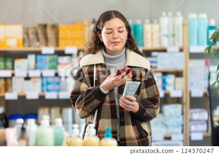 Young woman scanning qr code of cream 124370247