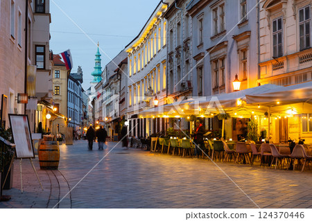 Picturesque evening view of Venturska street in center of Bratislava. Cafes and restaurants with illumination. Slovakia 124370446