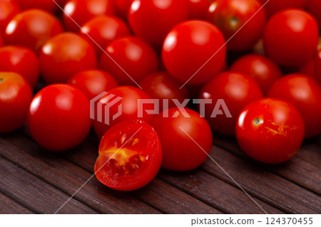 Fresh organic cherry tomatoes on wooden table 124370455