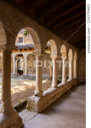 Shaded arched gallery around courtyard at Sant Llorenc de Morunys monastery 124370463