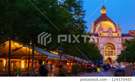 Central railway station of Antwerp and adjacent square with street cafes at twilight 124370485