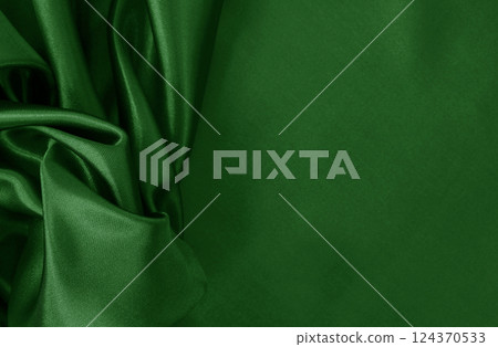 Dark green fabric cloth texture for background and design art work, beautiful crumpled pattern of silk or linen. 124370533