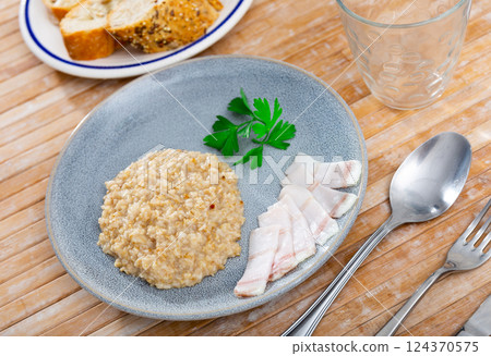Lard with hot oatmeal and parsley. Hearty healthy dish 124370575