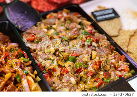 Marinated lamb with vegetables ready for stir-fry on store display 124370627