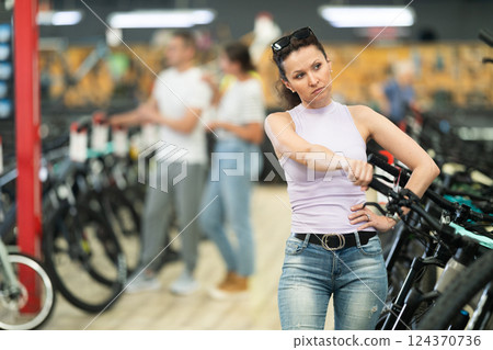 Adult woman choosing bike in store 124370736