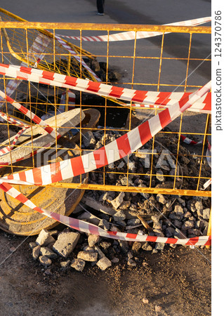 structure is metal with a red and white ribbon, dangerous territory. structure is metal with a red and white ribbon, dangerous territory. 124370786