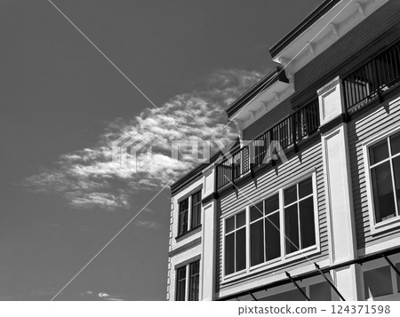 Top of residential building on cloudy sky background on a bright sunny day Top of residential building on cloudy sky background on a bright sunny day 124371598
