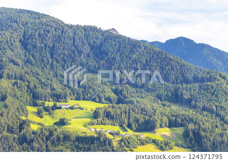 Mountain landscape mountains green fields forest clouds in Tyrol Austria. 124371795
