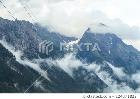 Mountain landscape mountains green fields forest clouds in Vorarlberg Austria. 124371822