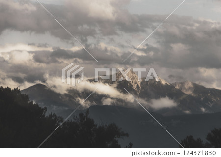 Mountain landscape mountains green fields forest clouds in Vorarlberg Austria. 124371830