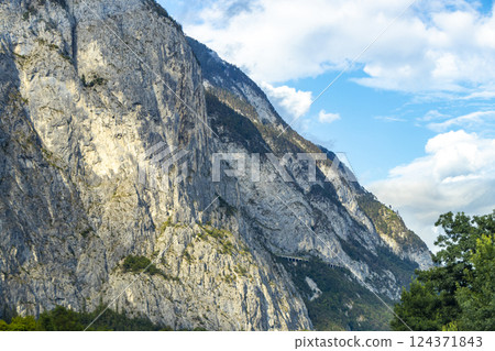 Mountain landscape mountains green fields forest clouds in Vorarlberg Austria. 124371843