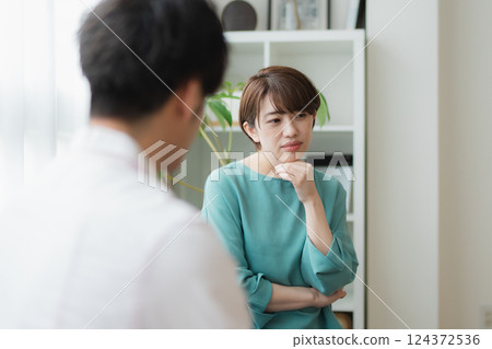 Young couple having a serious discussion - thoughtful expressions in the living room at home 124372536