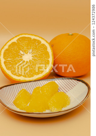 Cross section and peeled flesh of a Beni Natsumikan Cross section and peeled flesh of a Beni Natsumikan 124372986