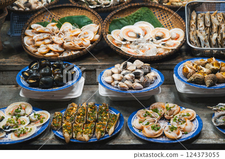 Snails and clams at Asian Seafood Street food night market in Vietnam. Vietnamese traditional food 124373055
