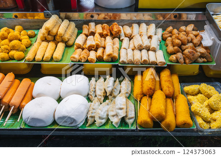 Traditional Vietnamese food and pastry at Asian night market on street in Vietnam in Asia Traditional Vietnamese food and pastry at Asian night market on street in Vietnam in Asia 124373063