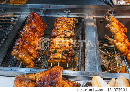 Grilled chicken is cooked at Asian street food night market in Vietnam Grilled chicken is cooked at Asian street food night market in Vietnam 124373064