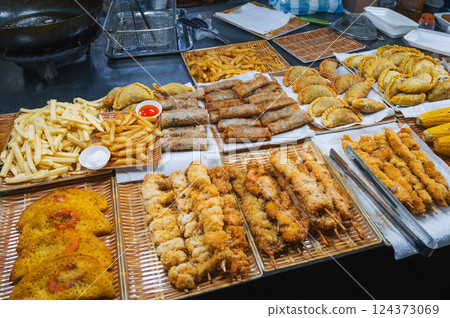 Traditional Vietnamese food and pastry on counter at Asian night market on street in Vietnam in Asia in Da Nang Traditional Vietnamese food and pastry on counter at Asian night market on street in Vietnam in Asia in Da Nang 124373069
