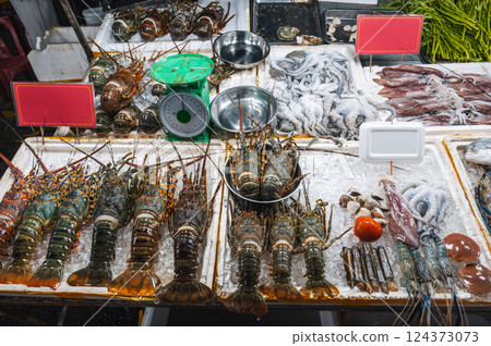 fresh lobsters and seafood on the counter at Asian night Food market in Vietnam in Asia fresh lobsters and seafood on the counter at Asian night Food market in Vietnam in Asia 124373073