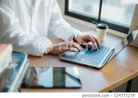 A young researcher concentrating on data analysis in a quiet office A young researcher concentrating on data analysis in a quiet office 124373239