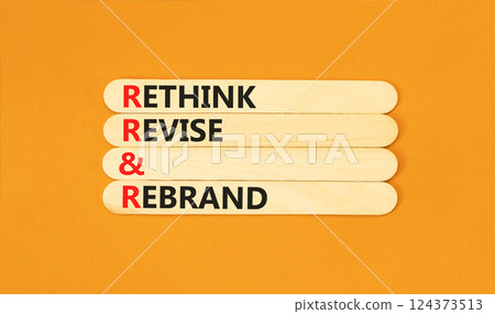Rethink revise rebrand symbol. Concept word Rethink Revise and Rebrand on beautiful wooden sticks. Beautiful orange background. Business brand rethink revise rebrand concept. Copy space. Rethink revise rebrand symbol. Concept word Rethink Revise and Rebrand on beautiful wooden sticks. Beautiful orange background. Business brand rethink revise rebrand concept. Copy space. 124373513