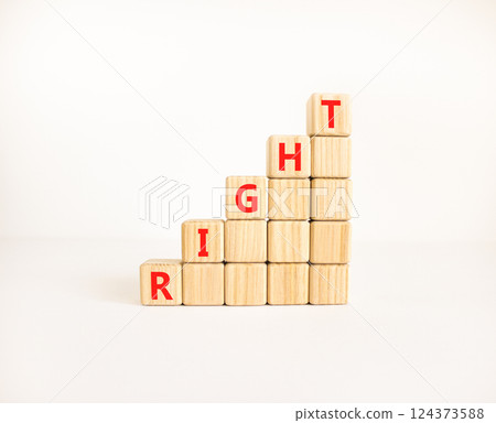 Right symbol. Concept word Right on beautiful wooden blocks. Beautiful white table white background. Business lifestyle right concept. Copy space. 124373588
