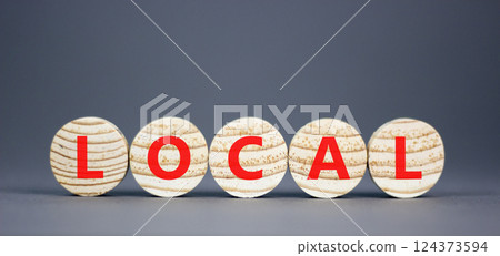 Local symbol. Concept word Local on beautiful wooden circles. Beautiful grey table grey background. Business lifestyle local concept. Copy space. 124373594