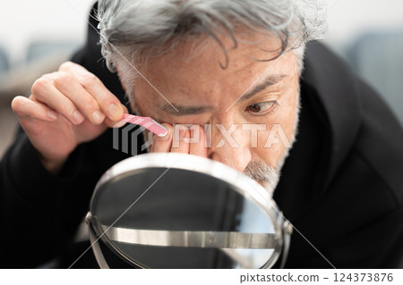 Mature men looking at mirrors Mature men looking at mirrors 124373876
